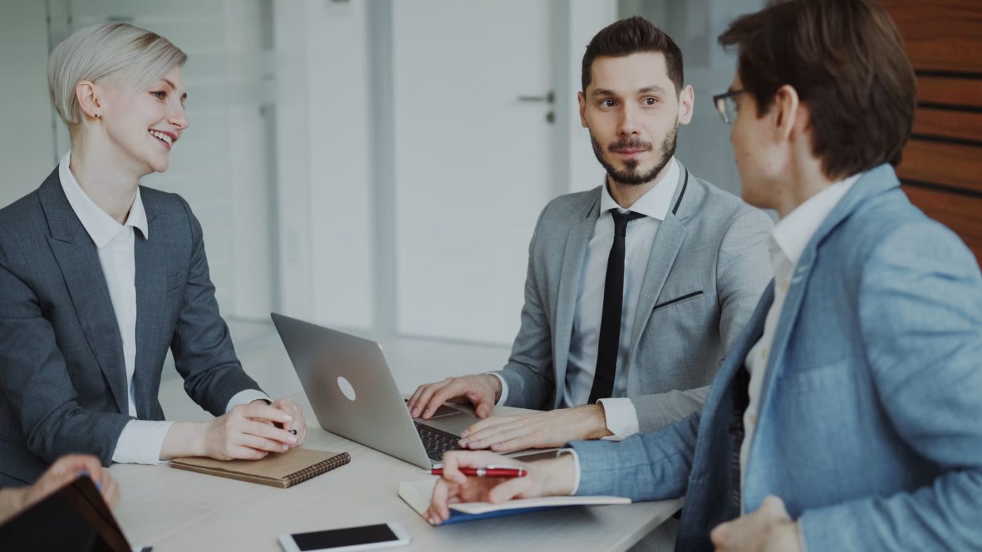 An adviser meeting with a client team