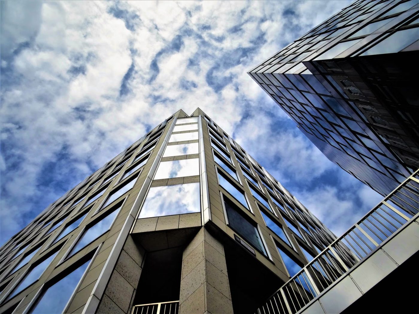 A glass office tower seen from below
